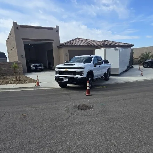 Jesse's pickup and enclosed trailer at a delivery in the desert