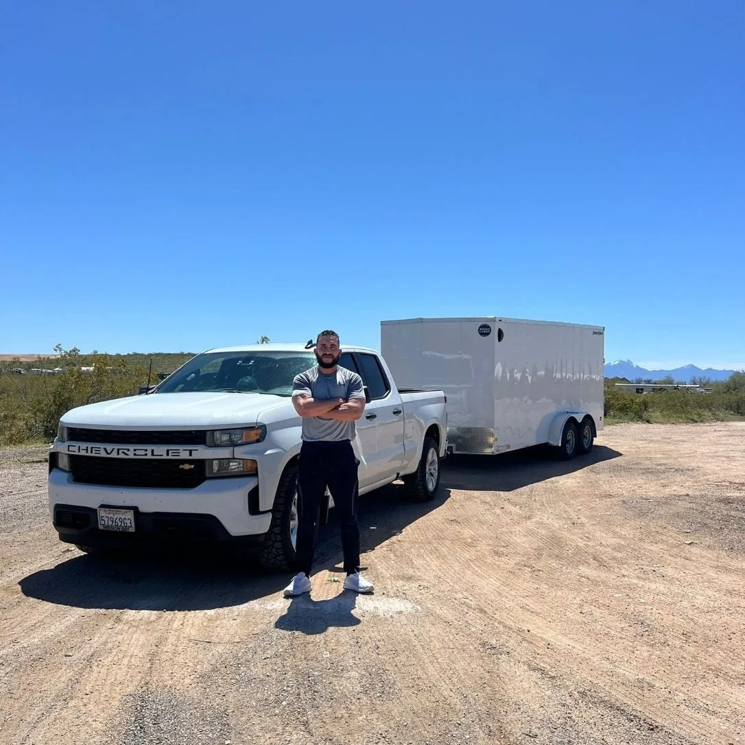 Jesse with his white pickup and enclosed trailer
