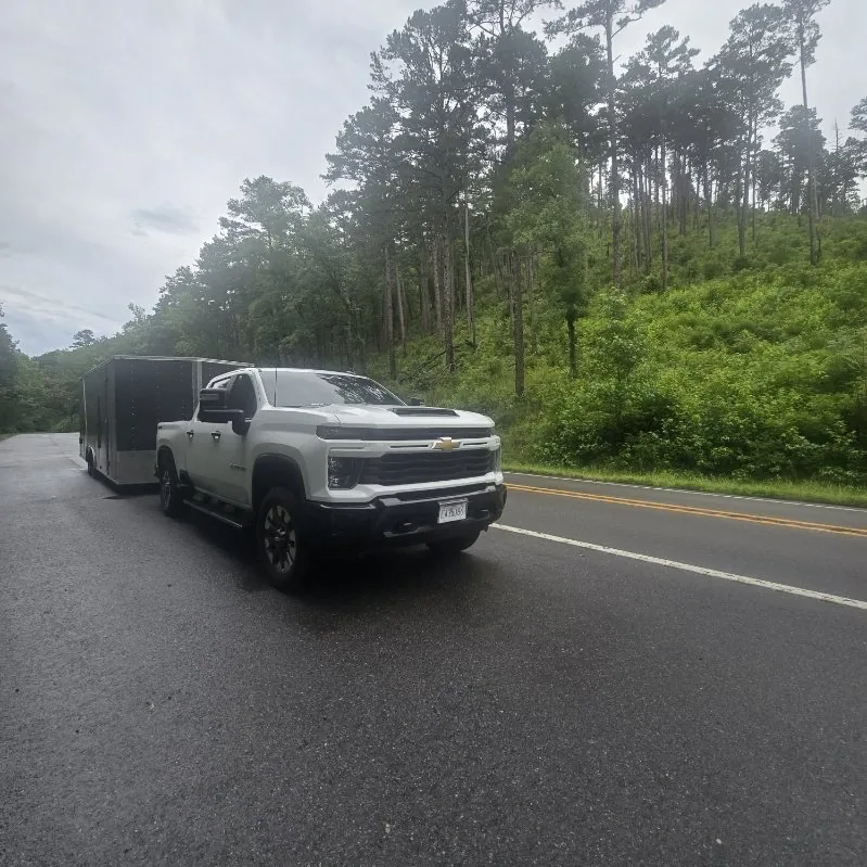 Jesse's pickup and trailer on a wooded highway